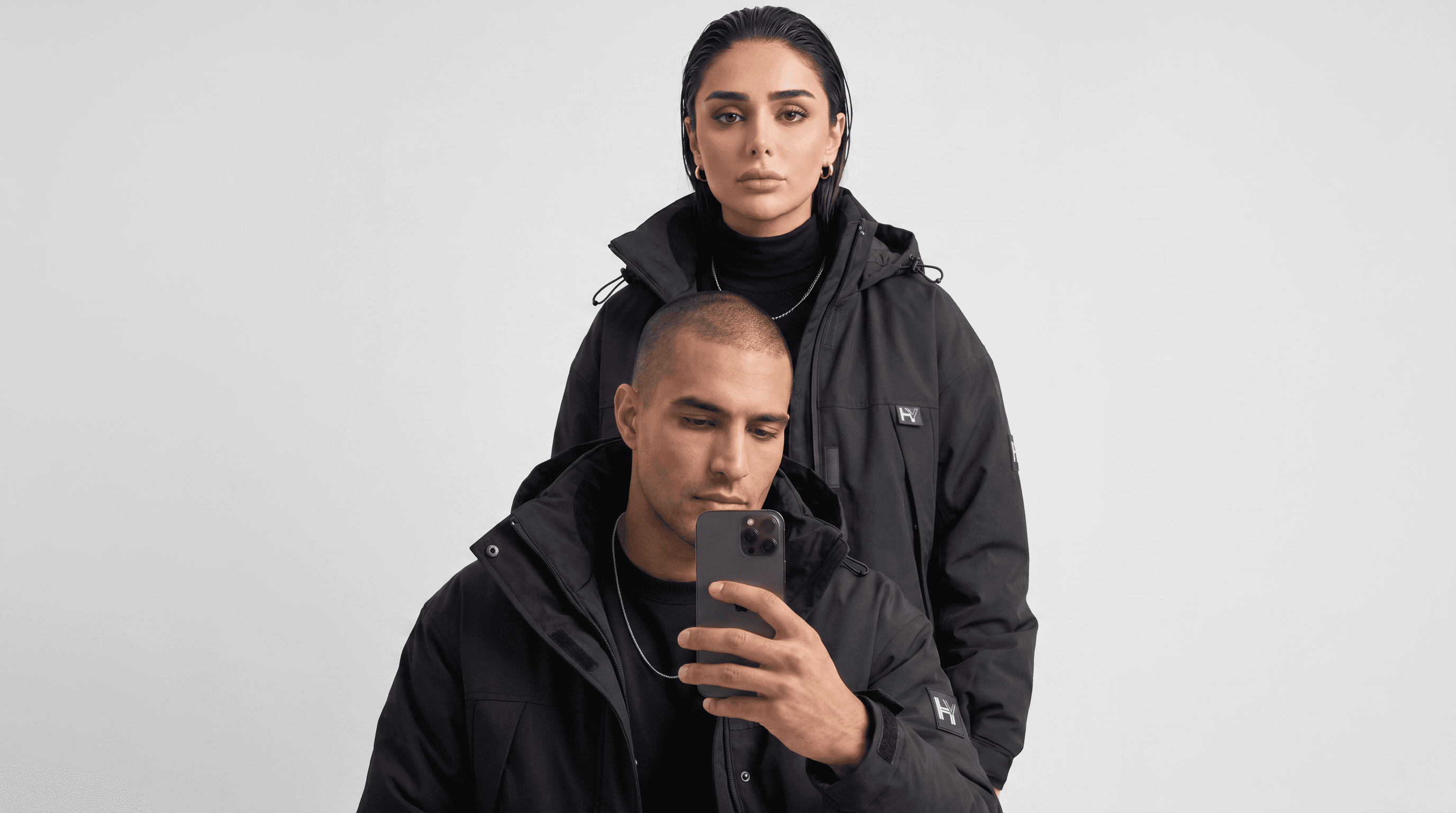 HYAENID debut campaign — two models in black technical outerwear